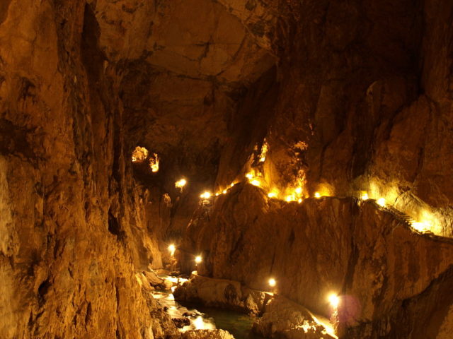 A photograph taken inside the Škocjan Caves in Slovenia. It is taken on the part of the cave that the river runs.