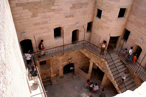 Tourists explore the château’s courtyard. Author: Sholybonoly CC BY-SA 2.5