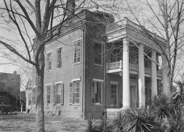 Kirkpatrick mansion on Oak Street, burned in 1935. The two-story brick slave quarters remains intact, however.