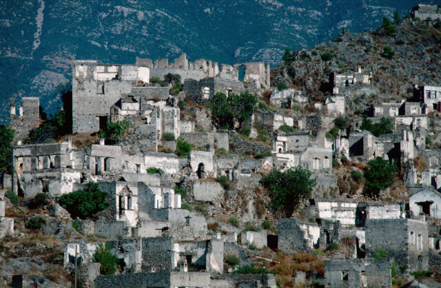 A view of stone buildings up a hillside.