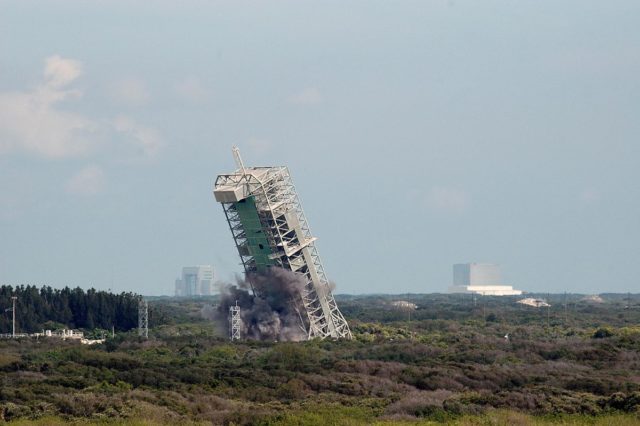 The MSS of Space Launch Complex 36A falls to the ground after critical supports are destroyed in a controlled explosion.