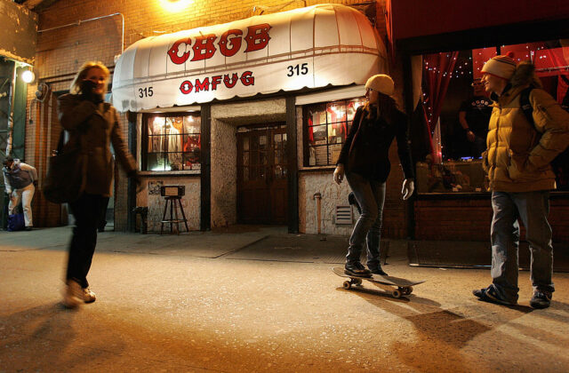 Three people standing outside of CBGB