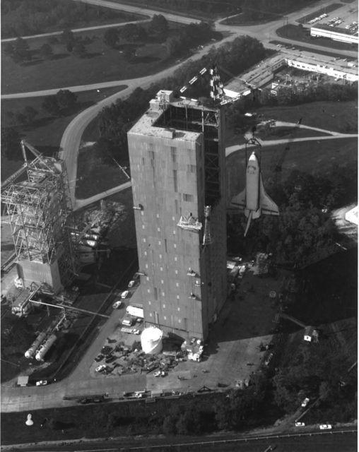 The Shuttle Enterprise is loaded into the Saturn V Dynamic Test Stand for a shake test, c. 1978