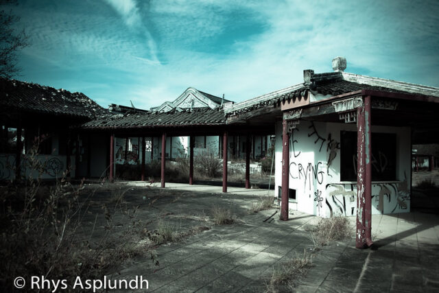 Exterior of a white building covered in graffiti