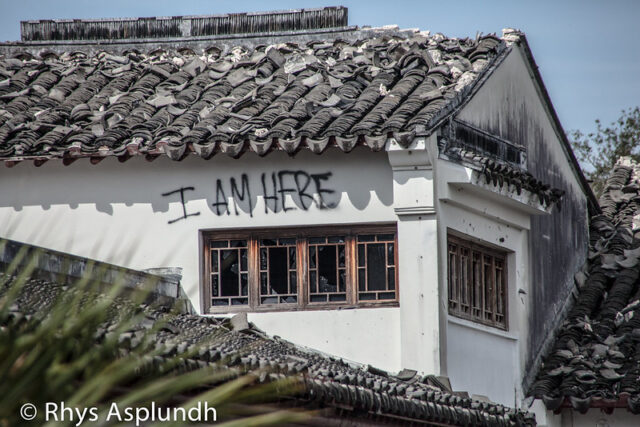 Exterior of a white building with graffiti