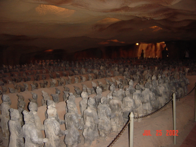 Replicas of the Terracotta Army in a dark cavern
