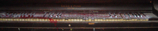 Bloody piano inside one of the abandoned buildings. Author: Christina Welsh CC BY-ND 2.0