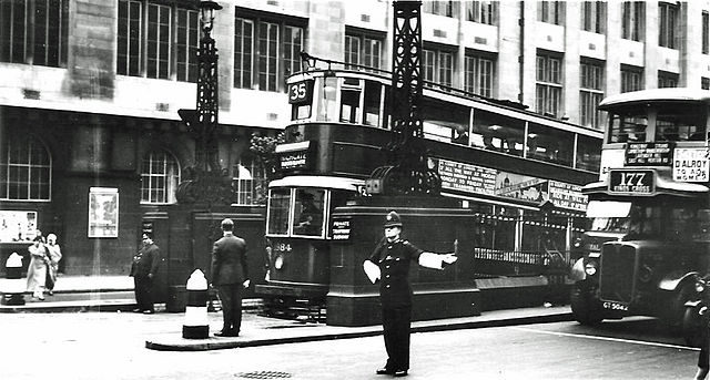 Kingsway Tram Tunnel in September 1933, just a few months after the London Passenger Transport Board took over the Central London tram system from the LCC. The No 35 tram is emerging from the northbound tunnel on its way to Highgate having started its journey in Forest Hill, South London. The Police Constable controlling traffic is probably from ‘E’ Division, either Holborn or Bow Street.