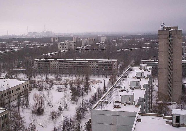 The city of Pripyat and the Chernobyl facility in the distance. Author: (WT-en) Kadams1970