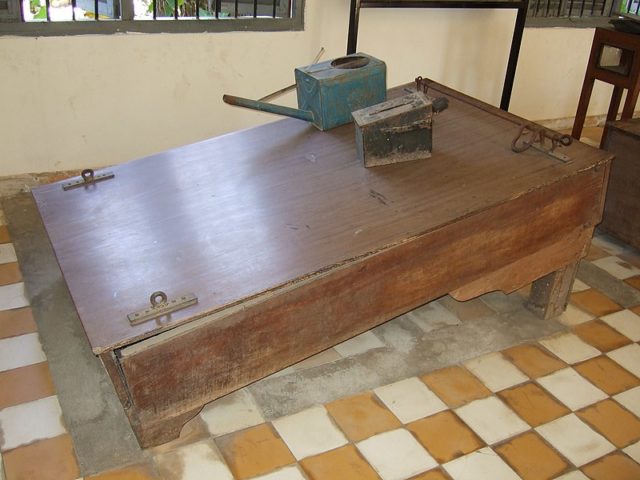 Waterboard displayed at Tuol Sleng. Author: waterboardingdotorg – CC BY 2.0