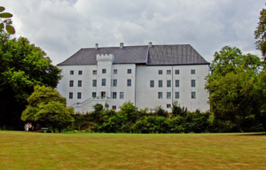 Dragsholm Castle surrounded by trees.