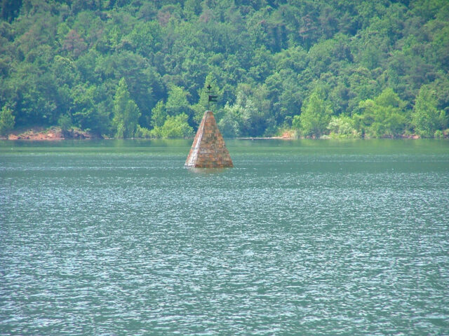 Bell tower roof pointing out of the water