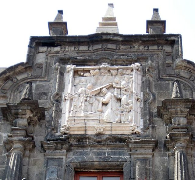 A relief detail on the upper portion of the portal.