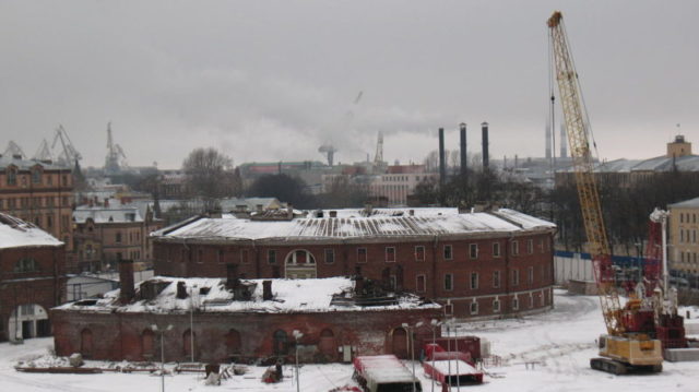 The view from the roof of an abandoned building on New Holland island, Saint-Petersburg, Russia towards a former prison (round building). Photo taken February 2009 by Serj nickel.