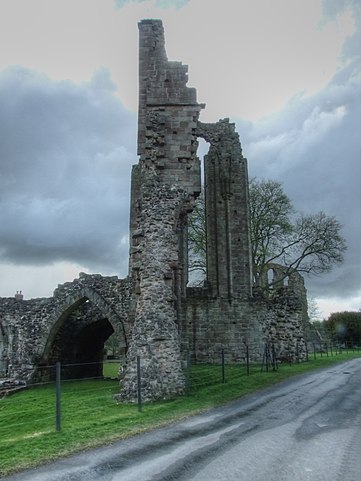 Stone wall ruins beside a road.