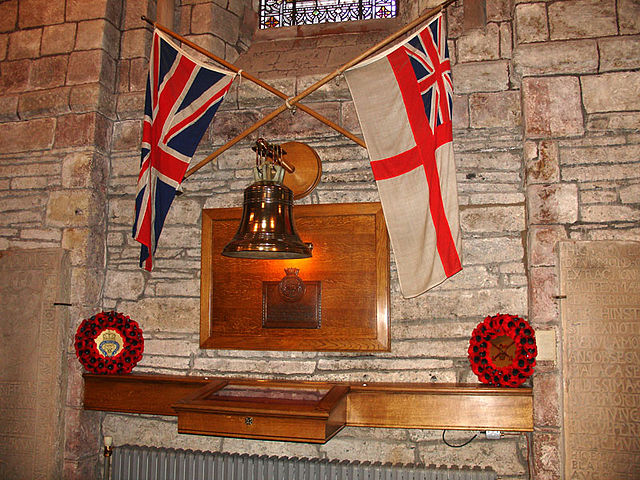 A memorial in St Magnus’ Cathedral, Kirkwall, featuring Royal Oak’s bell. Author: BillC CC BY-SA 3.0