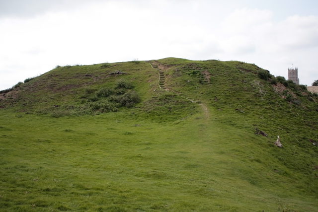 Walking up the motte of Fotheringhay Castle. Fotheringhay village church can be seen in the background Author: neil davies CC BY-SA 2.0