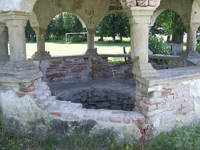 The well and its vandalised walls