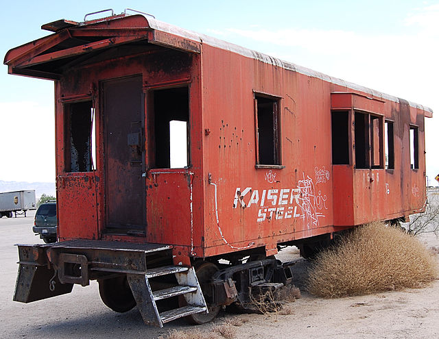 Red train caboose left in the desert