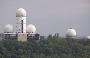 View of the towers of the Teufelsberg listening station rising above trees