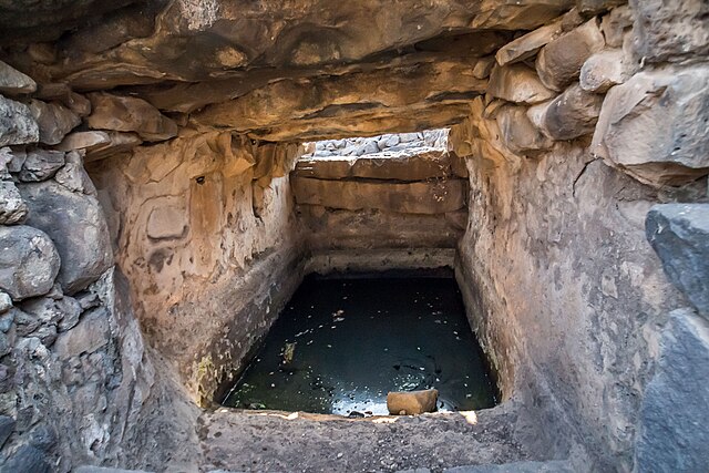 Water filling up a hole in an ancient structure at Chorazin