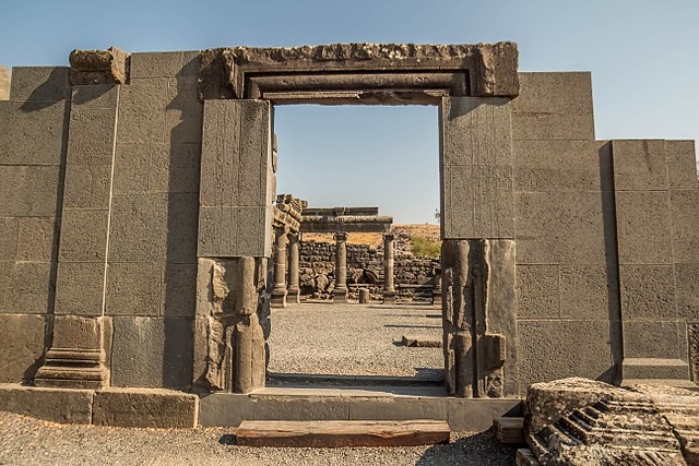 Entryway in a large slab of stone that's standing upright