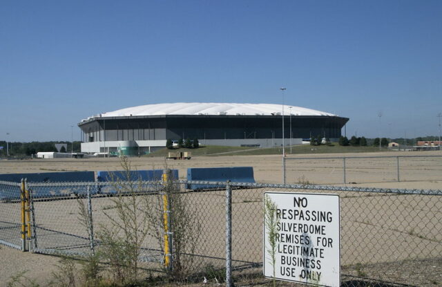 Metal gate and a "No Trespassing" sign around the Pontiac Silverdome