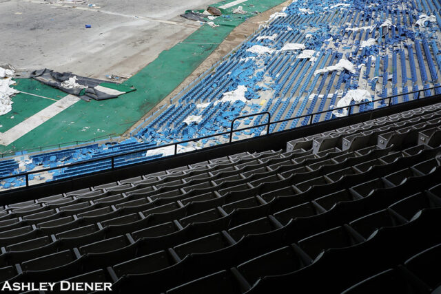 Rows of stadium seats in shadow