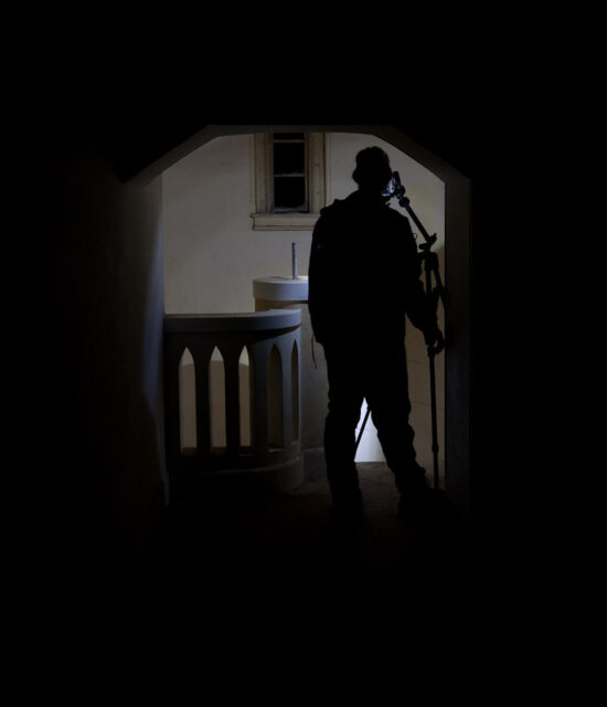 Man standing in a darkened doorway