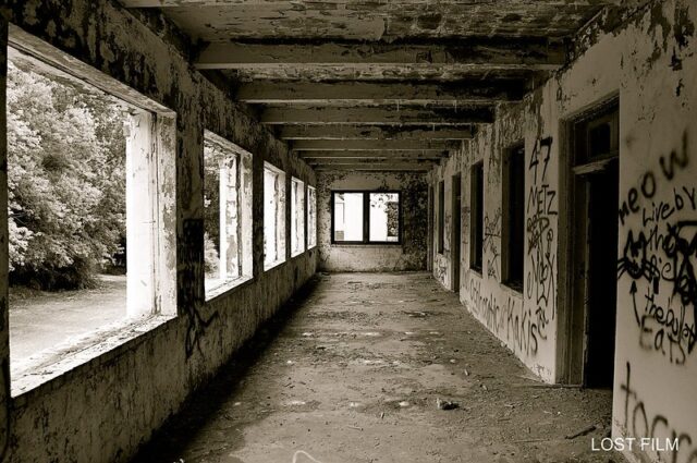 Exposed hallway covered in graffiti