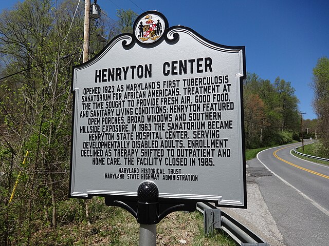 Plaque positioned along the side of a road