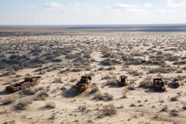 Aerial view of four ships stranded in the middle of the desert