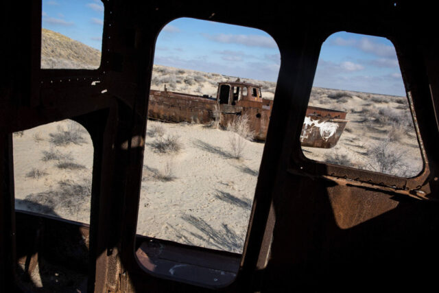 View of a stranded ship through a rusty structure