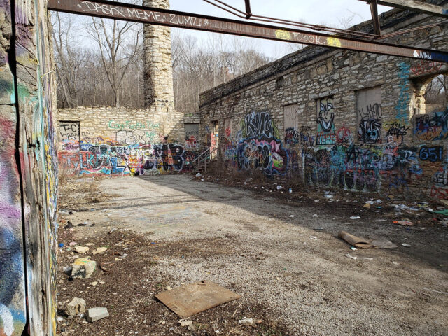 Alleyway between two walls that are covered in concrete