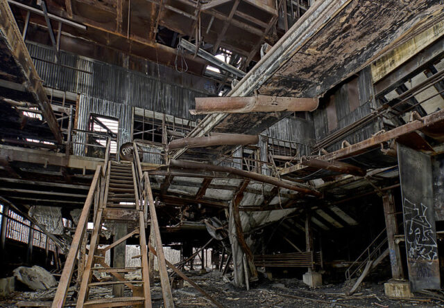 Damaged wooden staircase leading up to a rickety second floor