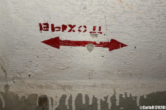 Sign containing a Russian word, giving directions in the bunker. (Photo Credit: CarloR)