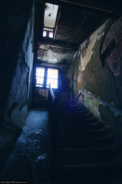 Looking up a staircase toward a bright window