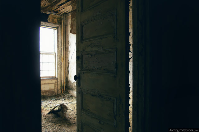 Looking into a window-lit room from the doorway