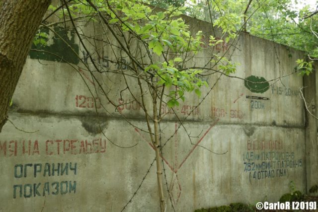 Exterior cement wall with writing on it