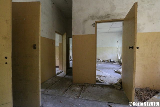 L-shaped hallway with doors open to other rooms