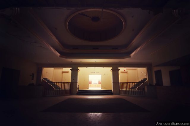 A large room in the Nevele Grand Resort lit at the end with staircases on either side