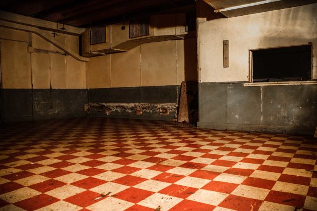 Empty room with a red and white tiled floor