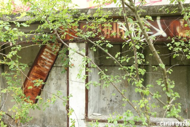 Rusty sign attached to concrete