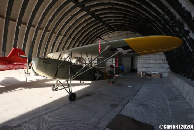 Grey and yellow airplane in a hangar