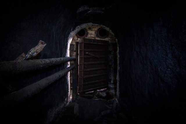 Hallway with a closed metal door at its end