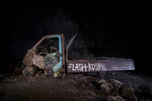 Rusty pickup truck with graffiti painted on its bed