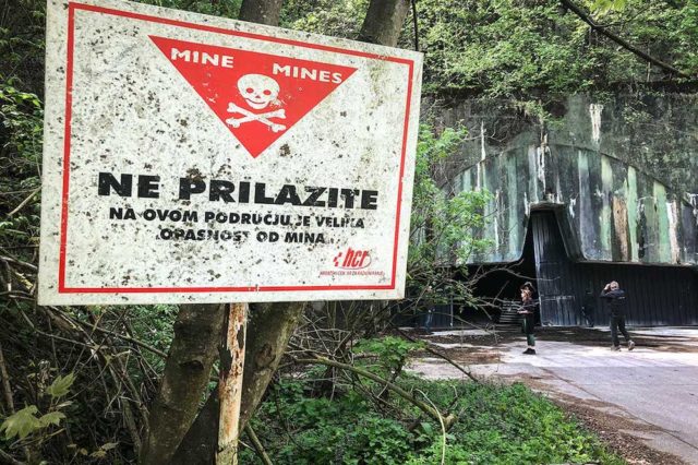 Sign warning about landmines outside of Željava Airbase