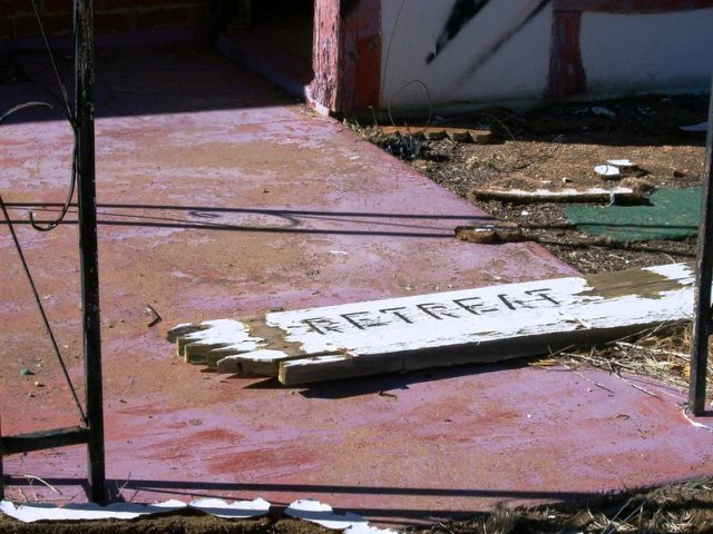 Broken wooden sign on the ground