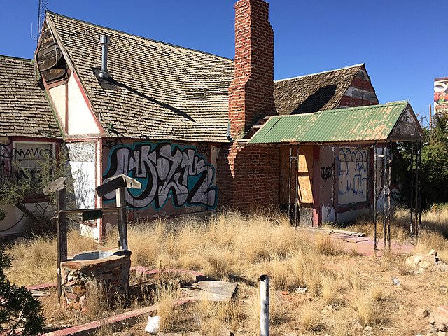 Dilapidated building with a wishing well in the front yard