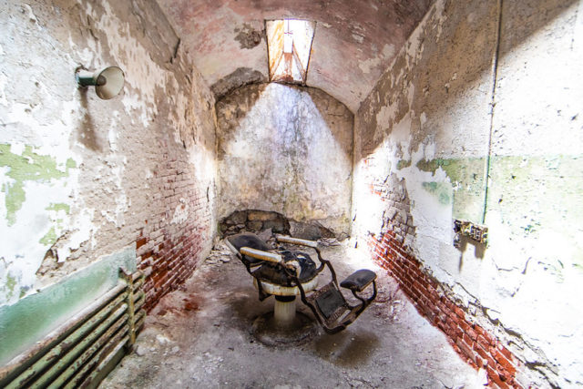 Broken barber's chair in the middle of a room